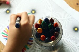 niño pintando con ceras de colores